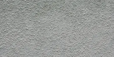 A close up of the wall with white paint.