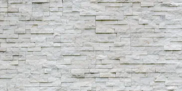 A white brick wall with many small bricks