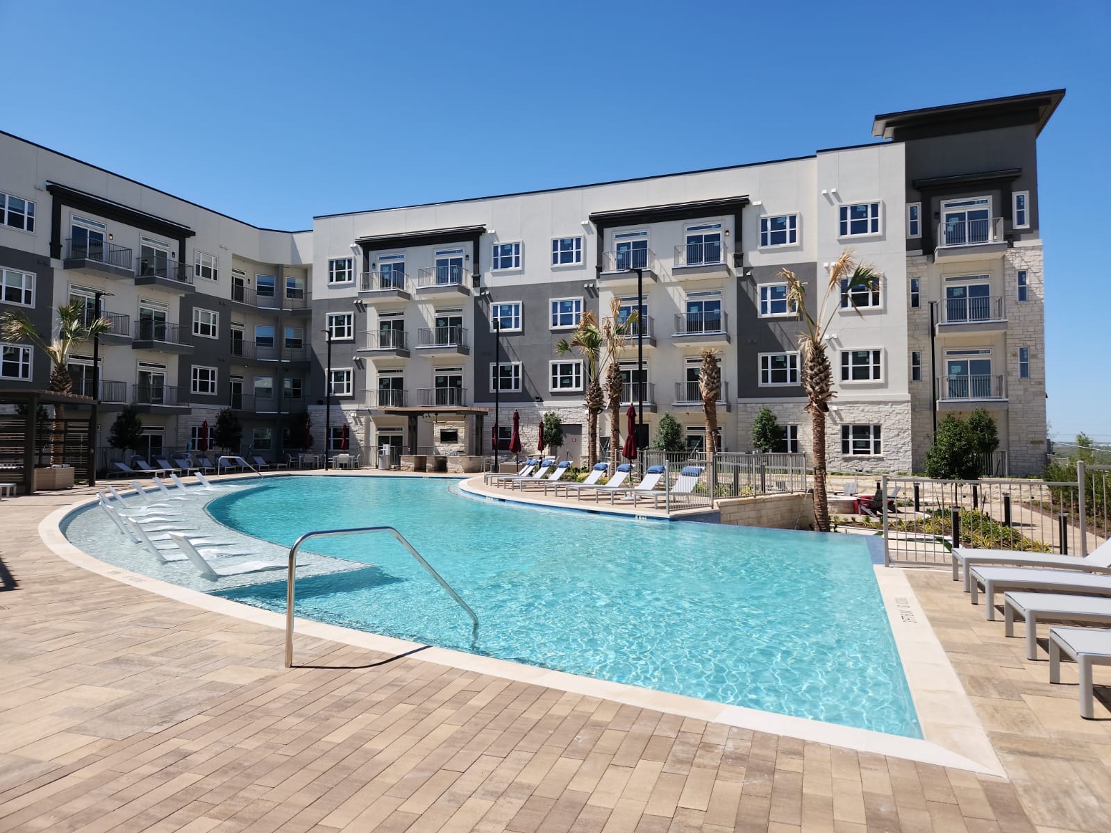 A large swimming pool with many chairs in the middle of it