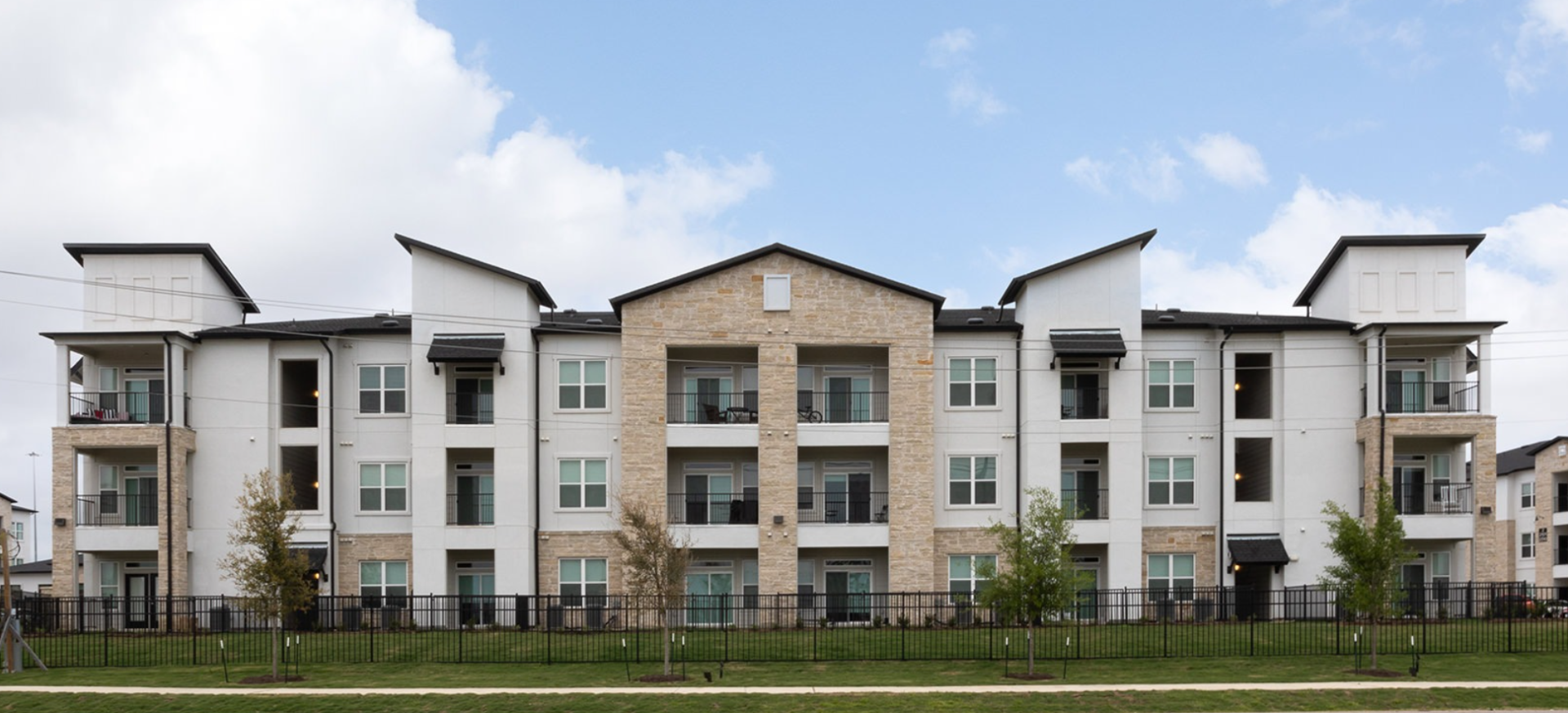 A large apartment building with many windows and balconies.