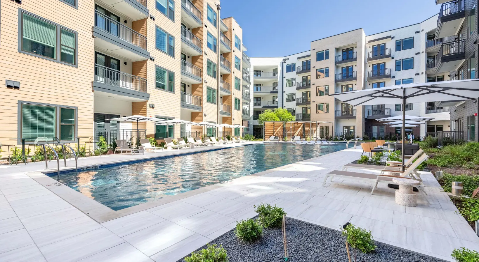 A pool with many buildings in the background